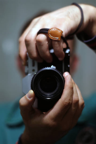 istock Photographer hands holding camera and taking photo 1370554283