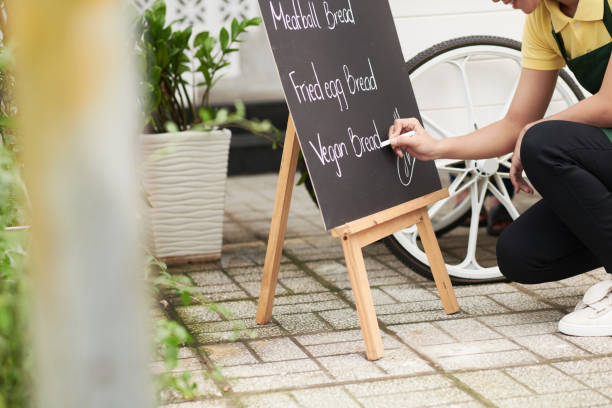 istock Food Cart Owner Writing Menu 1370554610