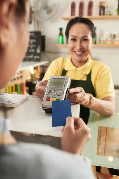 istock Barista Giving Card Reader to Customer 1370555520
