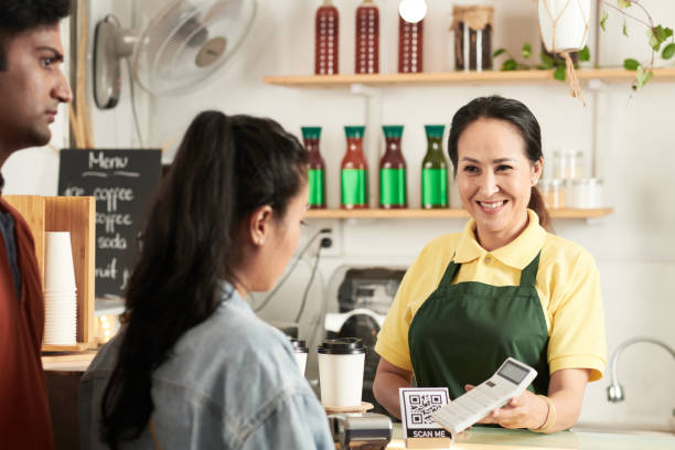 istock barista Showing Calculator to Customers 1370555529