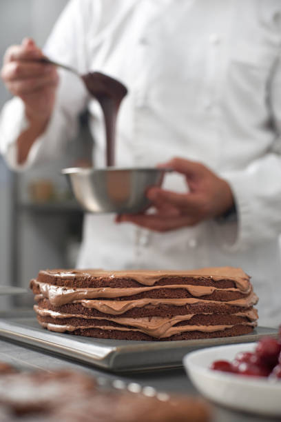 istock The work of a confectioner, making a cake. pastry chef in white uniform while working in a pastry shop. restaurant workflow in the kitchen. 1370557847