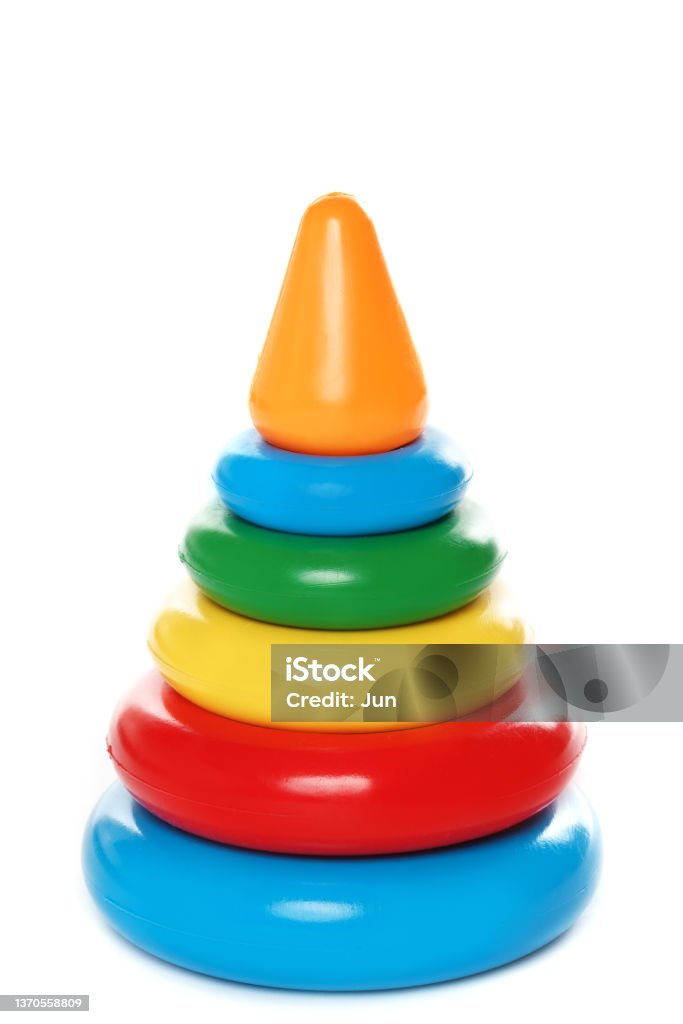 Colorful plastic stacking rings toy for little kids. Closeup shot of a colorful plastic stacking rings toy for little kids on white background. Stacking Stock Photo