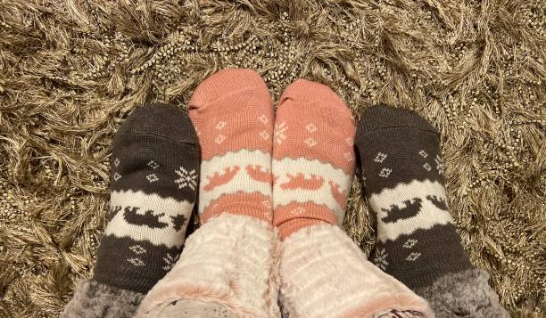 istock Couple with warm feet in winter socks 1370559587