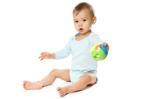 istock Little boy in romper sitting and playing with plastic toy. 1370560018