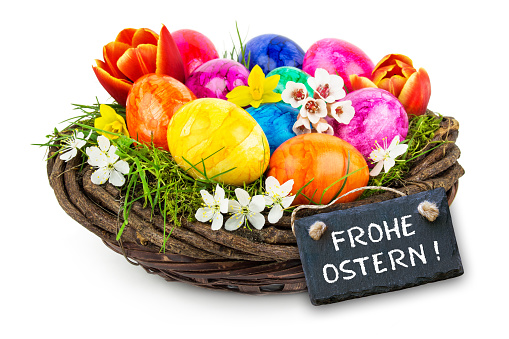 Colorful Easter decoration eggs with label and German Happy Easter on white background