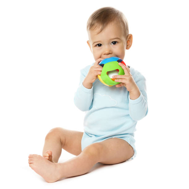 istock Little boy in romper sitting and playing with plastic toy. 1370560070