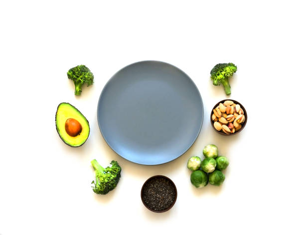Ingredients for proper nutrition and empty blue plate on white background. The concept of healthy diet.