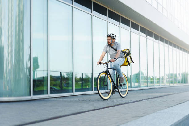 istock Express delivery courier riding bicycle with insulated bag. 1370561479