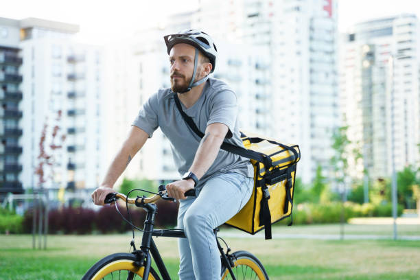 istock Express delivery courier riding bicycle with insulated bag. 1370561552
