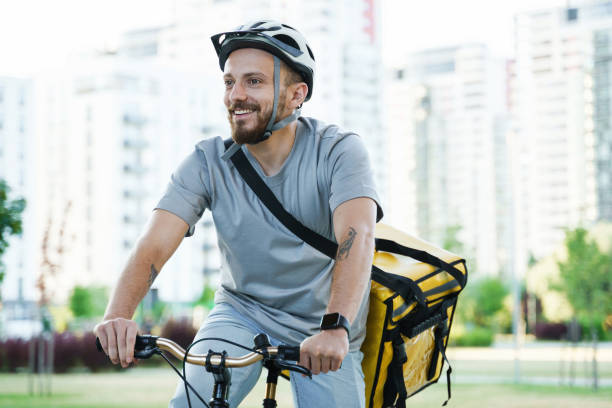 istock Express delivery courier riding bicycle with insulated bag. 1370561878