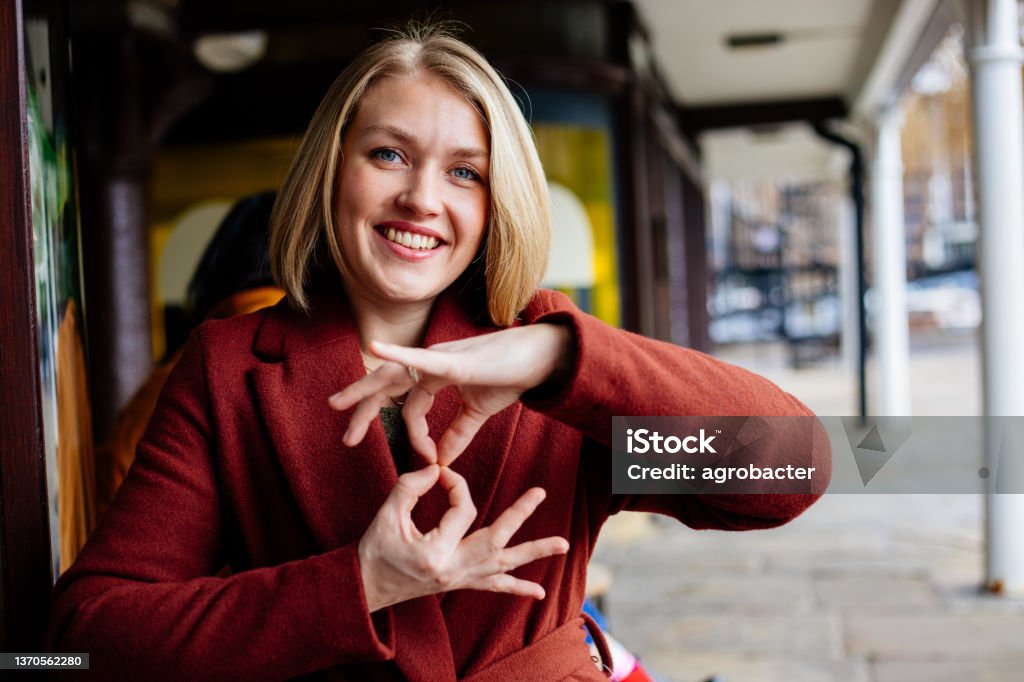 Beautiful woman using sign language Sign Language Stock Photo