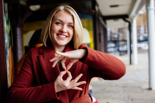 Beautiful woman using sign language stock photo
