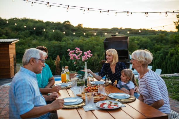 istock Multi-generation family having dinner outdoors in the backyard 1370563743