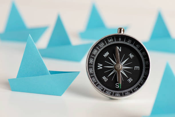 istock Blue Paper Boats With Compass 1370564303