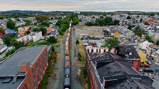 Drone shot of a freight train passing through Reading, Pennsylvania on an overcast afternoon in Fall. \n   \nAuthorization was obtained from the FAA for this operation in restricted airspace.