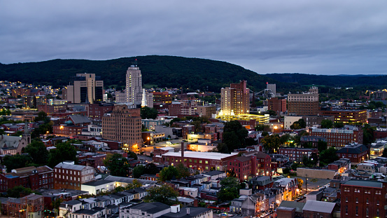 Aerial shot of illuminated buildings in downtown Reading, Pennsylvania on an overcast evening in Fall.\n   \nAuthorization was obtained from the FAA for this operation in restricted airspace.