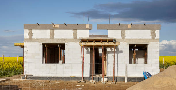 istock Rural house under construction with rapeseed field in background 1370569822