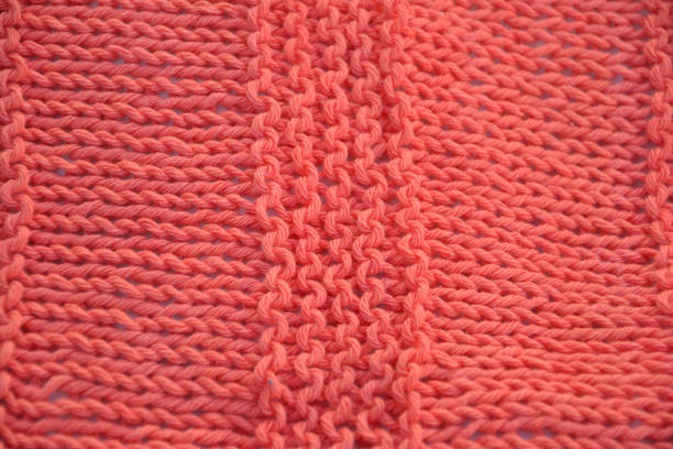 istock coral color two needle knitting 1370571123