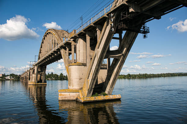 istock Arched railway bridge across the river in summer. Merefo-Kherson old bridge over the Dnieper river. Dnepropetrovsk, Ukraine 1370571246