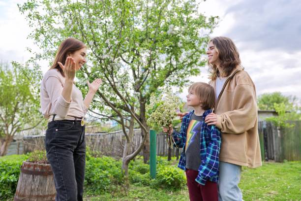 istock Mother's day concept. Two sons congratulating mom 1370571481