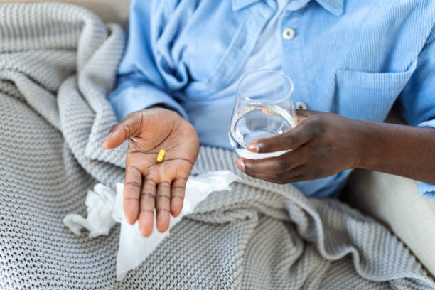 black man hold pills and jar in his hands. concept of healthcare and medicine, patient take daily dose of prescribed medicament, feel sick, antibiotics, painkillers or antidepressants. close up - narcotic medicine pill insomnia imagens e fotografias de stock