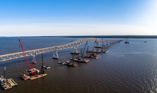 Aerial view of the reconstruction of the Governor Harry W. Nice Memorial/Senator Thomas “Mac” Middleton Bridge connected Virginia and Maryland, with multiple floating cranes vessels along with the construction site on the Potomac River.