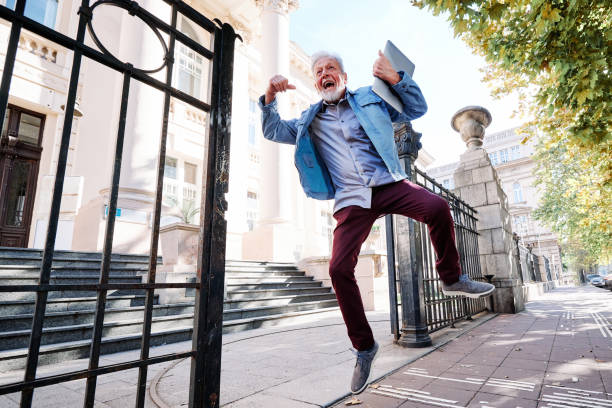 istock A happy senior student on the retraining program passed the exam and he is jumping with joy and happiness. 1370573628