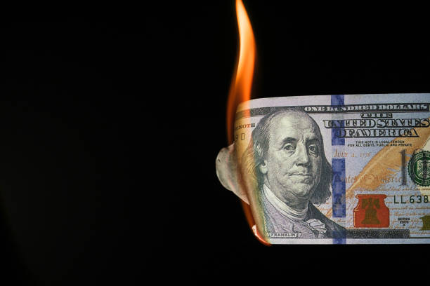 istock Close up shot of a 100 dollar banknote burning 1370575632