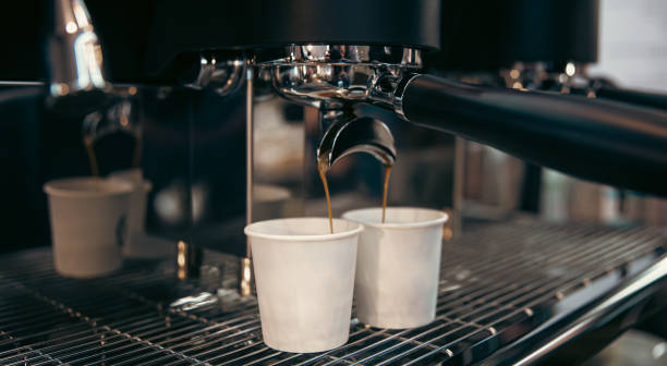 istock The process of preparing espresso in a professional coffee machine, close-up. 1370575853