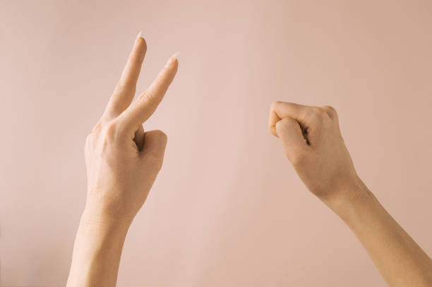 istock Hands Gesture for Rock  Scissor Game, isolated on pink background. 1370576701