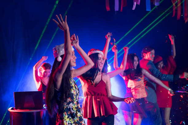 istock Cheering crowd young people at New Year - holiday celebration background 1370576926