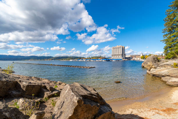 vue depuis une petite plage au bord du lac sur tubbs hill de la station, du lac, de la marina et de la promenade à coeur d’alene, idaho usa un jour d’été. - dalene photos et images de collection