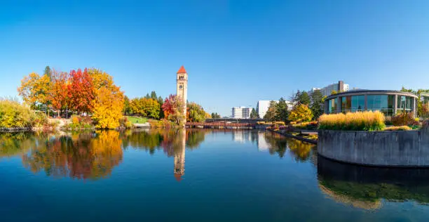 Panoramic wide angle view of Riverfront Park including the clocktower, expo pavilion and looff carrousel along the Spokane River at autumn in Spokane, Washington, USA