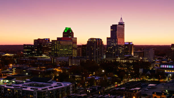istock Illuminated Office Buildings in Raleigh, NC at Dusk - Drone Shot 1370580610