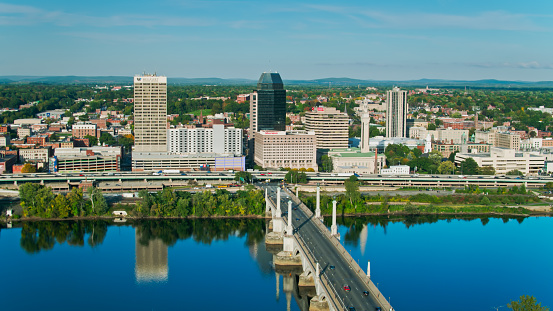 Aerial shot of downtown Springfield, Massachusetts on a sunny day in early Fall, looking along Memorial Bridge across the Connecticut River from West Springfield.