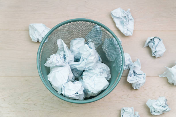 istock Overflowing waste paper in office garbage bin. Trash concept 1370585210
