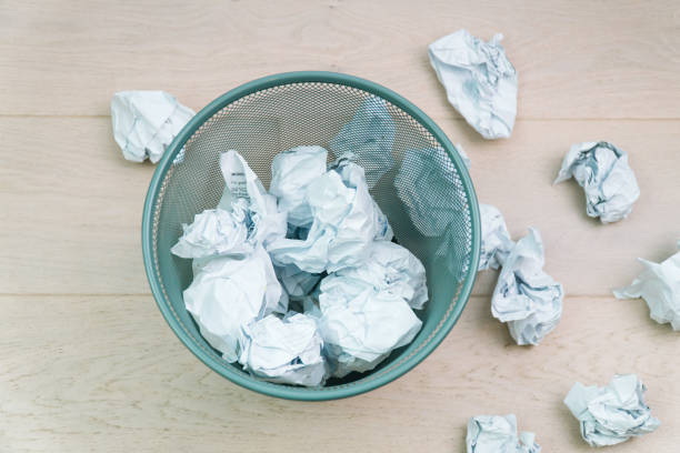 overflowing waste paper in office garbage bin. trash concept - computer delete bildbanksfoton och bilder