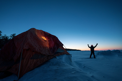 Setting up tent while camping in winter mountain