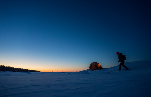 Setting up tent while camping in winter mountain