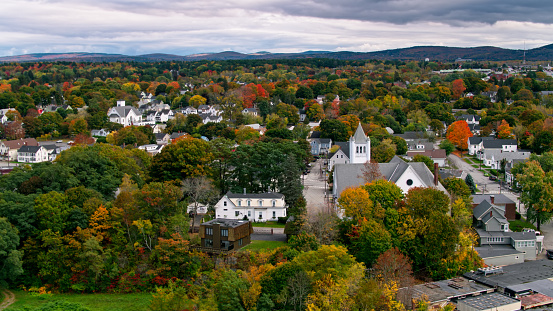 Aerial shot of Brewer, Maine on a cloudy day in Fall, shot from across the river in Bangor.
