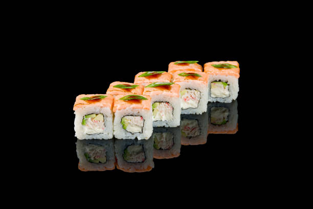 istock roll with baked salmon and crab on black with reflection 1370587413