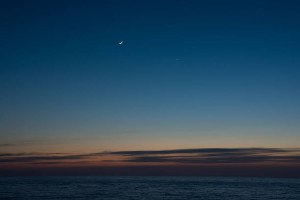 istock Crescent and Venus in the beautiful sea dusk sky 1370588152