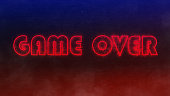 neon text game over on black concrete wall