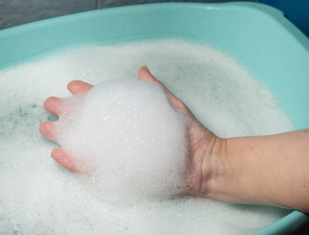 istock Foam in hand. Washing dishes. Washing basin. 1370590054