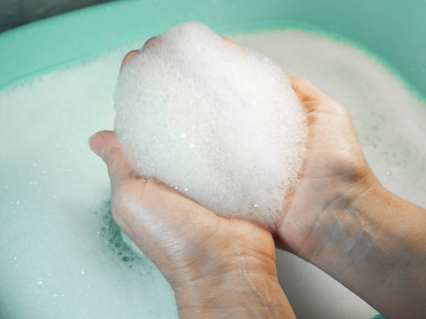 istock Foam in hand. Washing dishes. Washing basin. 1370590055