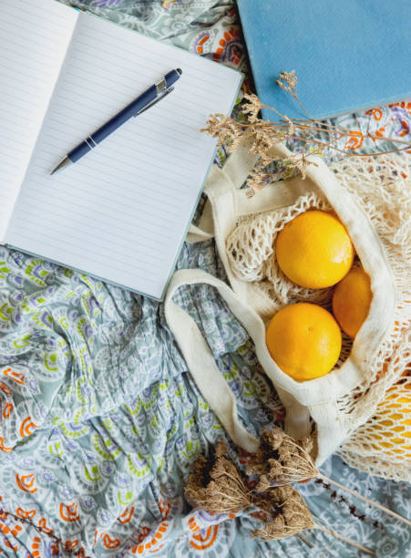 istock summer picnic flatlay, fruits, oranges in string bag, notes and laptop on cotton blanket, freelance work, outdoor office 1370590284