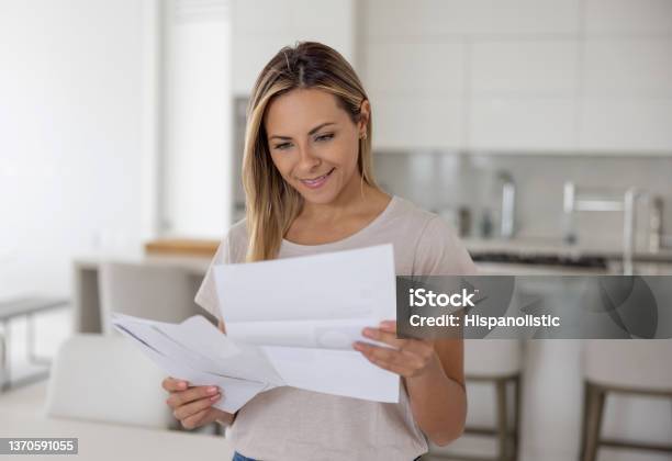 Woman At Home Reading A Letter In Her Mail Stock Photo - Download Image Now - Letter - Document, Mail, Women