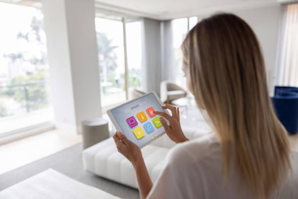 istock Woman controlling the lights of her house using a tablet computer 1370591065