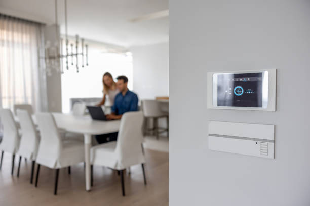 Close-up on a controller at a smart home Close-up on a controller at a smart home - home automation system concepts. **DESIGN ON SCREEN WAS MADE FROM SCRATCH BY US** indoor security camera stock pictures, royalty-free photos & images