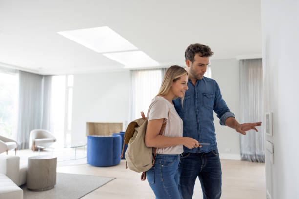 istock Couple leaving their house and setting the alarm using a home automated system 1370591094
